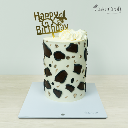 Leopard-print themed cake with elegant black and brown animal print and a 'Happy Birthday' topper by Cakecroft.