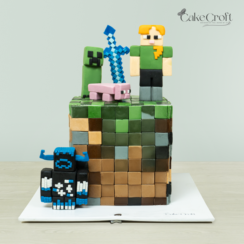 Minecraft-themed cake with iconic game characters, blocks, and tools crafted by Cakecroft.