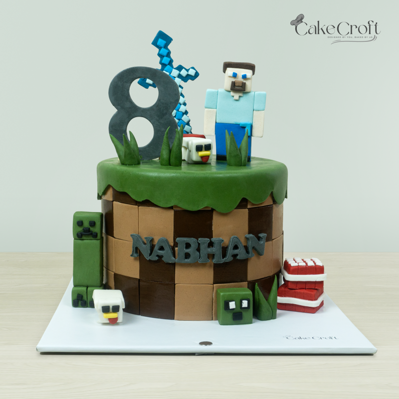 Minecraft-themed cake with blocky character, green grass topper, and personalized name for an 8-year-old's birthday.