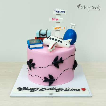 Travel-themed cake with airplane, suitcase, and destination signs for an adventurous birthday celebration.