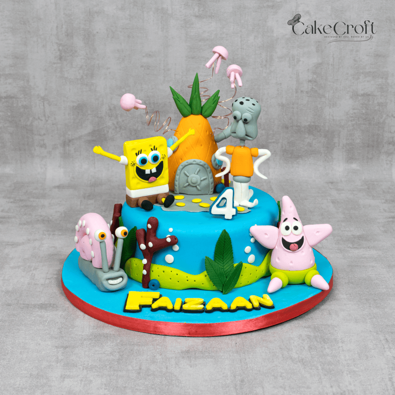 A vibrant SpongeBob SquarePants-themed cake with fondant figures of SpongeBob, Patrick, Squidward, and Gary, along with the iconic pineapple house and undersea decorations.