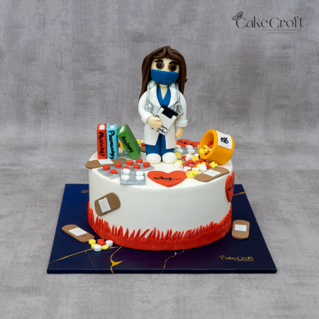 Medical-themed cake with fondant female doctor, medicine bottles, books, pills, and medical decorations.