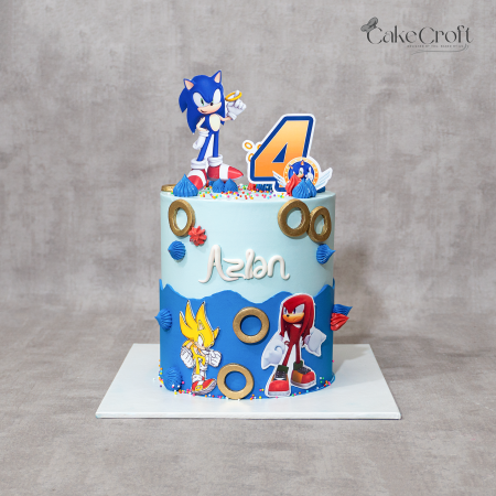 Sonic the Hedgehog theme birthday cake with blue buttercream, gold rings, and Sonic, Knuckles, and Super Sonic toppers by CakeCroft Dhaka.