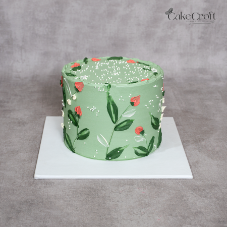 Sage green buttercream cake with hand-painted floral design and edible pearls by CakeCroft Dhaka.