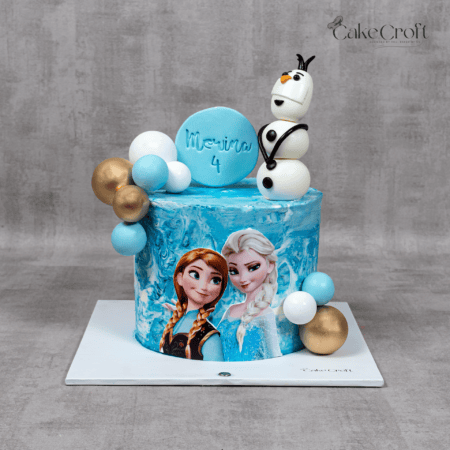 Frozen Elsa Anna Olaf themed birthday cake with blue marble frosting and gold accents in Dhaka