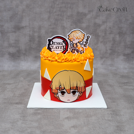 Demon Slayer Zenitsu themed birthday cake with yellow-orange frosting, anime toppers, and geometric decorations.