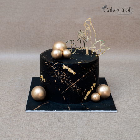Black and gold bride to be cake with elegant bridal shower topper