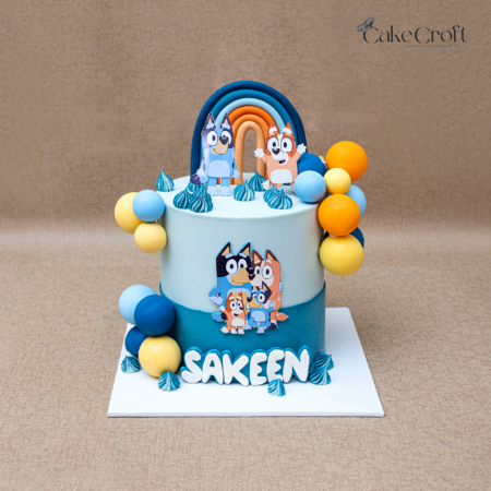 Bluey themed custom birthday cake with rainbow topper and name Sakeen