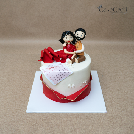 Romantic fondant couple cake with calendar date design for engagement celebration in Dhaka